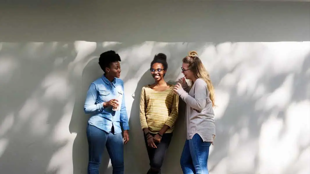 Three students having a happy conversation
